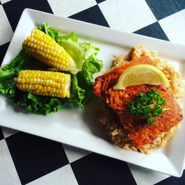 A plate with rice and corn on it.