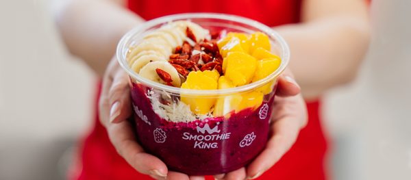 A bowl of fruit and nuts.