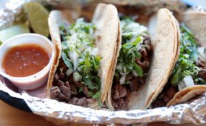 a plate of tacos and sauce on a table