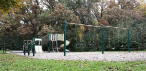 a playground with a swing set and a slide