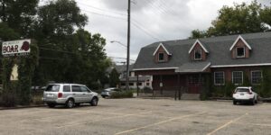 a parking lot with cars parked in front of a building