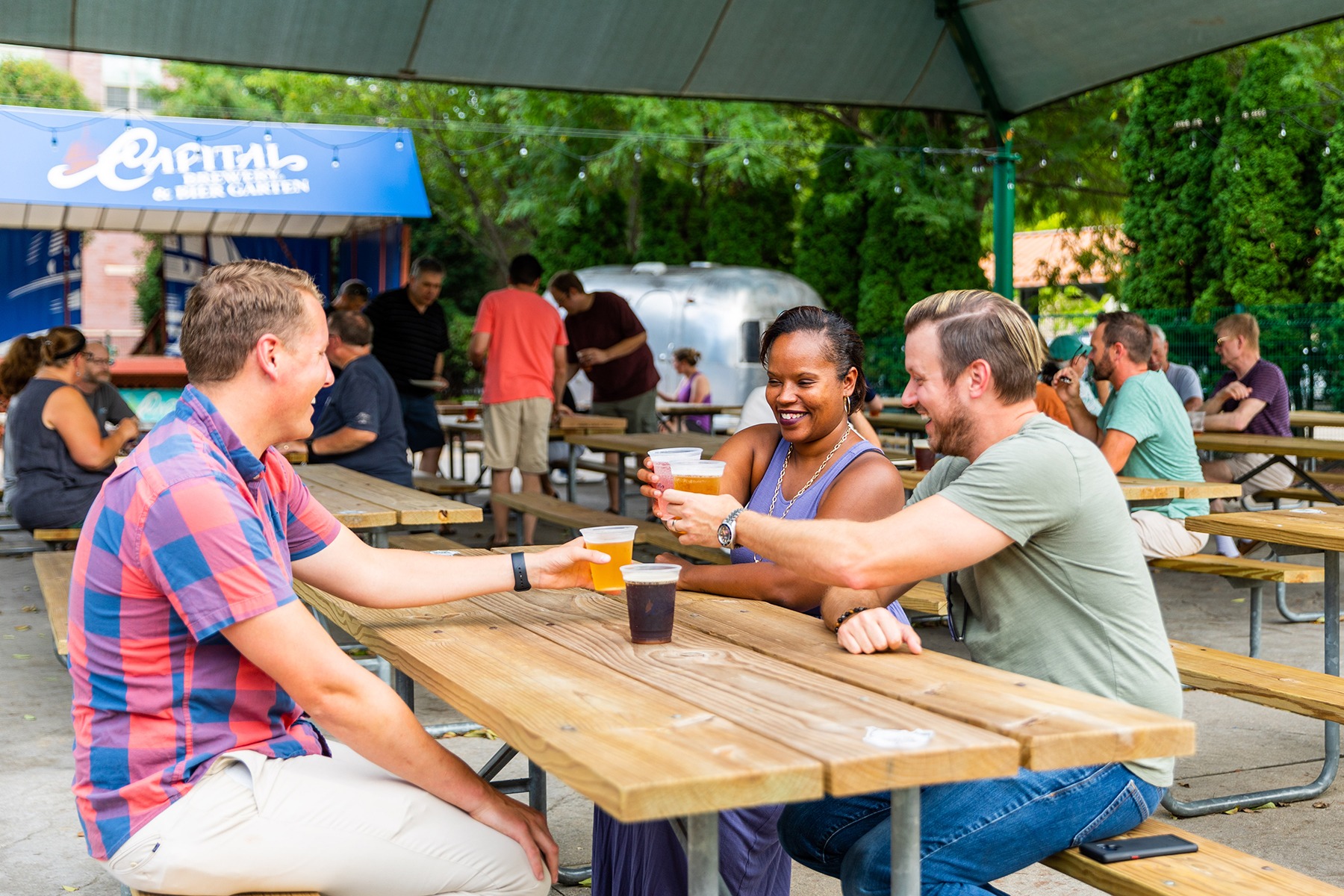 a group of people sitting around a wooden table