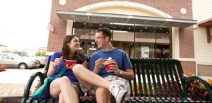a man and a woman sitting on a bench