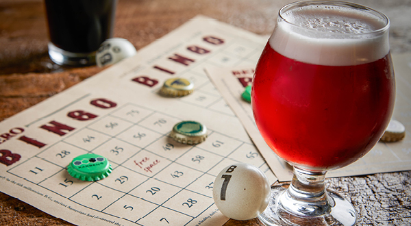 a glass of beer sitting on top of a table.