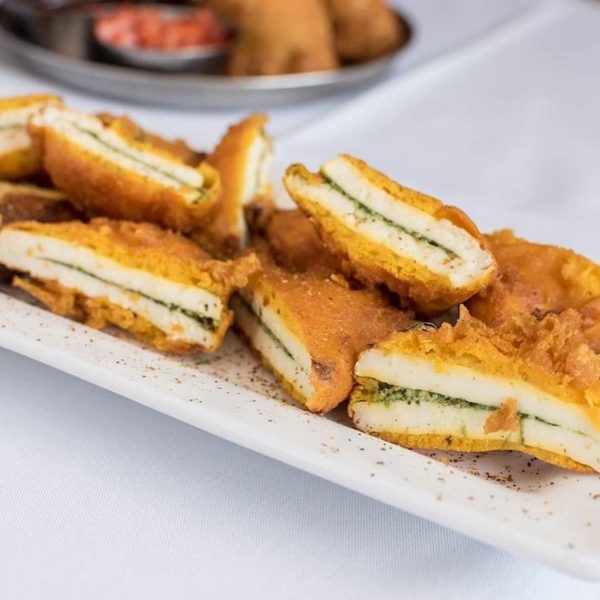 A plate of fried chicken stuffed with spinach and cheese.
