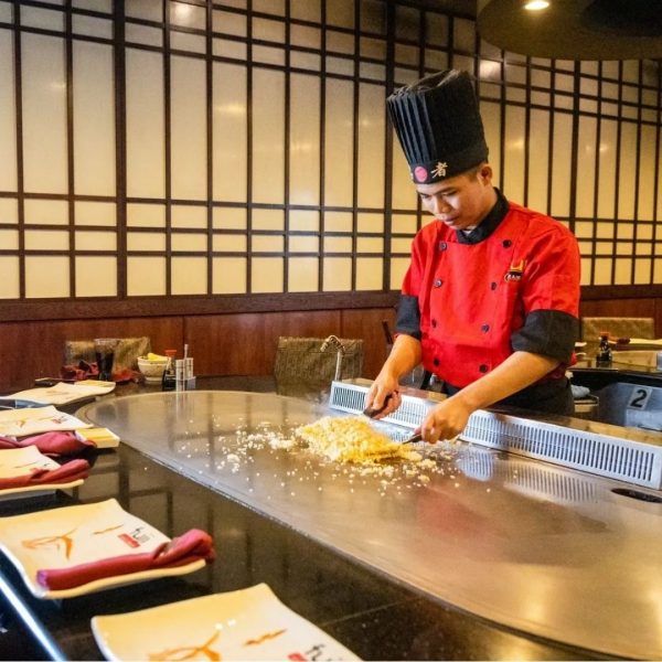 A chef is preparing food in a restaurant.