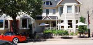 a red car parked in front of a house