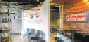 a living room with a tv and chairs