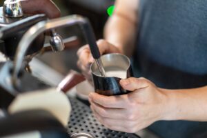 a close up of a person holding a cup of coffee