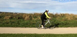 a person riding a bike down a road