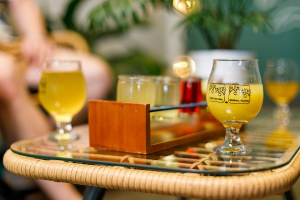 A glass of beer on a table.