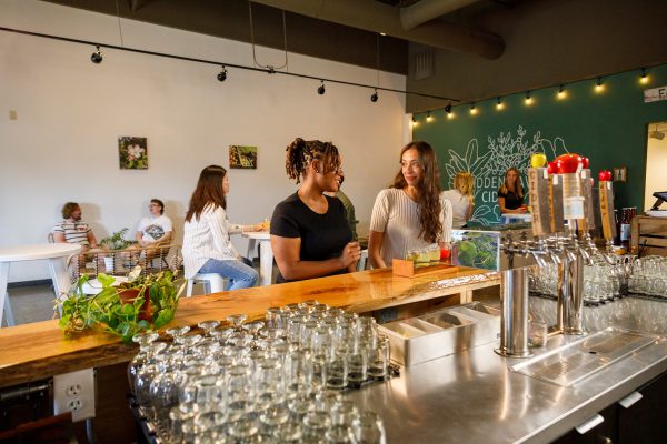 Two women standing at the counter of a coffee shop.