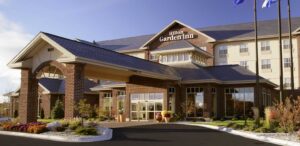 the front of a hotel with a flag flying in the wind