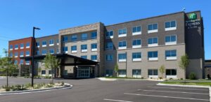 the front of a hotel with a parking lot