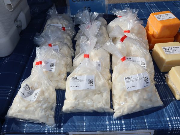 a table topped with lots of bags of cheese.