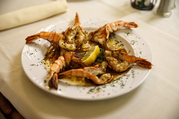 A white plate with shrimp on it.