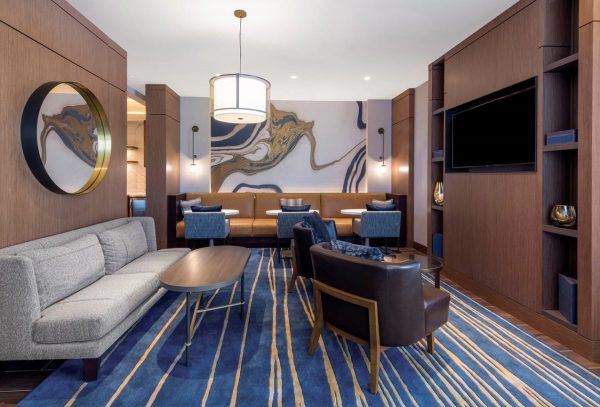 a living room with couches, chairs and a television.