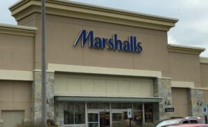 a store front with cars parked in front of it