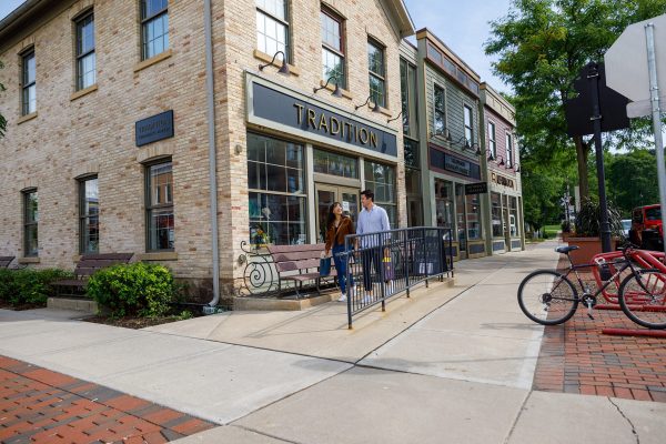 a couple of people standing outside of a building.