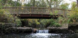 a bridge over a river with a waterfall