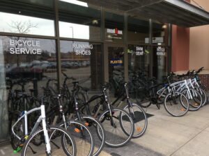 a bunch of bikes are parked outside of a bicycle service