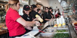 a group of people preparing food in a kitchen