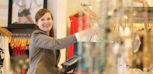 a woman standing in front of a display of clothing