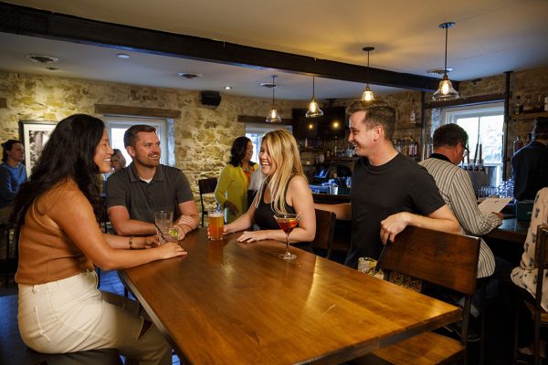 A group of people sitting at a table in a restaurant.