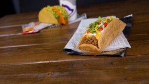 a close up of a hot dog on a napkin on a table