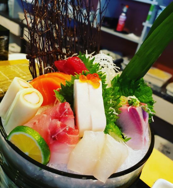 A bowl of sashimi on a table.