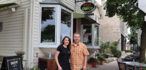 a man and woman standing in front of a store
