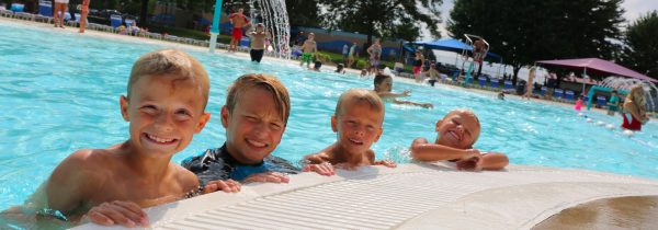 a group of children are in a swimming pool