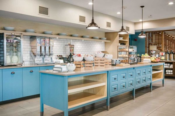 A kitchen with blue cabinets and counter tops.